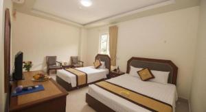 a hotel room with two beds and a television at Hai Long Hotel Cat Ba in Cat Ba +47 photos