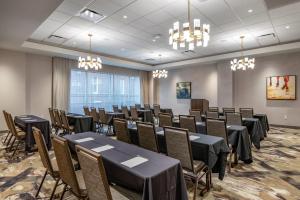 a conference room with tables and chairs and chandeliers at Cambria Hotel Louisville Downtown-Whiskey Row in Louisville +48 photos