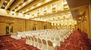 a large banquet hall with white chairs in it at Regency Art Hotel in Macau +227 photos