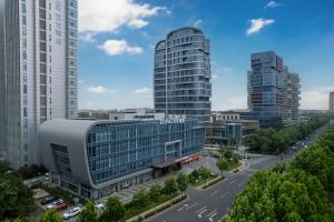 arial view of a city with tall buildings at Qingdao Huangdao Golden Beach Art Dragon Hotel in Yantaiqian