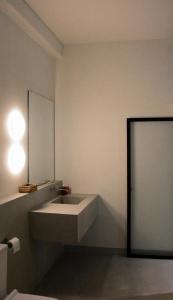 a bathroom with a sink and a mirror at Nova Surf House in Matara