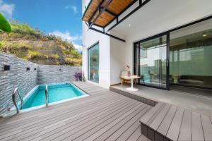 an outdoor deck with a swimming pool and a house at Heaven's Gate Lodge XMAN-Free pick up in Zhangjiajie