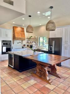 a large kitchen with a wooden table in it at Casa Catalina - Luxury Desert Oasis in Tucson