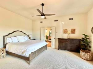 a bedroom with a bed and a ceiling fan at Casa Catalina - Luxury Desert Oasis in Tucson