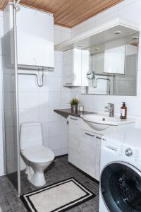 une salle de bain avec un lavabo et une machine à laver dans l'établissement Gammi Apartments - Classy Lapland Stay in Rovaniemi Centre for up to 4 Guests, à Rovaniemi