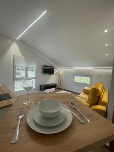 a dining room with a table with a bowl on it at Apartamento ALMORCHÓN - Hotel Ruta del Segur in Pontones