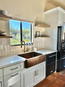 a kitchen with a sink and a large window at Casa Catalina - Luxury Desert Oasis in Tucson