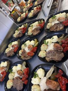a bunch of plates of food on a table at Pensiunea El Greco in Axente Sever