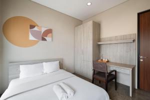 a hotel room with a bed and a desk at Cove Heritage in Binong