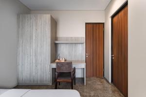 a bedroom with a desk and a chair in a room at Cove Heritage in Binong