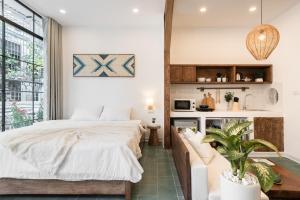a bedroom with a bed and a couch at Lakeside Horizon Boutique Suites-1 min to Hoan Kiem Lake-Free Airport in Hanoi +46 photos