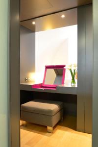 a room with a desk with a bench and a stool at Pestana Cidadela Cascais - Pousada & Art District in Cascais