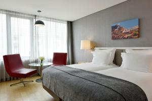 a hotel room with a bed and a table and chairs at Pestana Cidadela Cascais - Pousada & Art District in Cascais