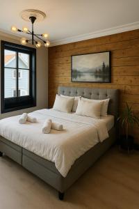 a bedroom with a large bed with white sheets at A Place To Stay Stavanger, apartment 6 in Stavanger