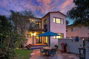 een huis met een tafel en stoelen en een paraplu bij West Beach Villa 5 in Santa Barbara