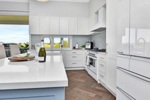 a kitchen with white cabinets and a white counter top at Stellaview Estate in Mitchells Flat +43 photos