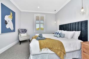 a bedroom with a large bed and a chair at Stellaview Estate in Mitchells Flat