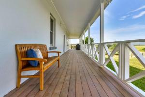 a wooden porch with a bench on a house at Stellaview Estate in Mitchells Flat +44 photos