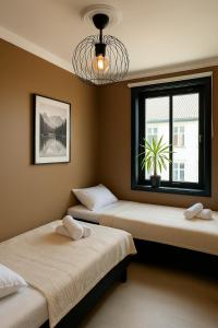 two beds in a room with a window at A Place To Stay Stavanger, apartment 6 in Stavanger