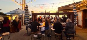 een groep mensen die aan tafels in een restaurant zitten bij West Beach Villa 3 in Santa Barbara
