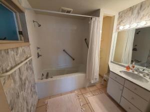 a bathroom with a tub and a sink at Family Vacation Home - Stunning Views across Salt Pond in Bethany Beach +76 photos