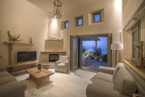 a large living room with a couch and a table at Sunrise Pelion Sea View Villas in Chorefto