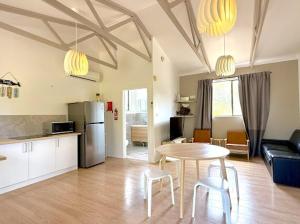 a kitchen and a living room with a table and chairs at Beachside Cabin No 2 at Island Beach in Island Beach