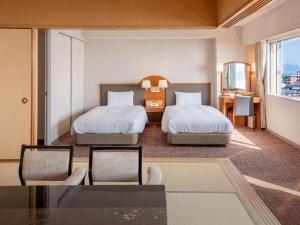 Una cama o camas en una habitación de Imazu Sun Bridge Hotel