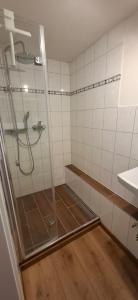 a shower with a glass door in a bathroom at bei GRETA 35 in Marl