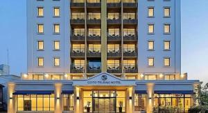 a large building with a sign on the front of it at Goto Tsubaki Hotel in Hukue