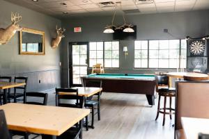 a restaurant with a pool table and tables and chairs at Country Inn & Suites by Radisson, Prairie du Chien in Prairie du Chien