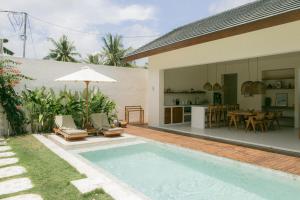 a villa with a swimming pool and a house at Summer Promo - 2 BR villa, big pool & garden in Kuta Lombok