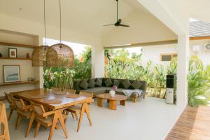 a living room with a table and a couch at Summer Promo - 2 BR villa, big pool & garden in Kuta Lombok