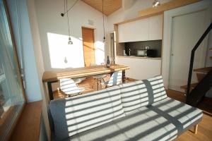 a living room with a couch and a kitchen at Apartment Oton Reya in Dobrovo