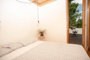 a bedroom with a bed and a patio with a table at Apartment Oton Reya in Dobrovo