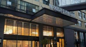 a building with a sign on the side of it at Shanghai Manhattan Hotel Minhang in Shanghai