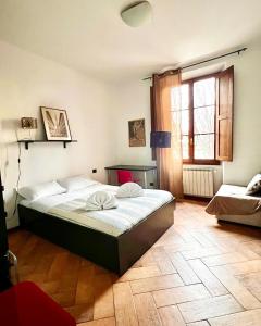 フィレンツェにあるMy happy placeのベッドと窓とソファのある寝室