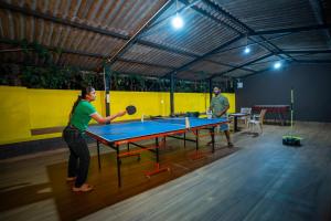 two people playing ping pong in a ping pong table at Streamedge Sakleshpur in Hanbalu