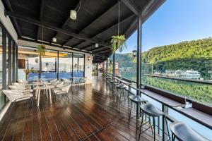 a restaurant with chairs and tables and a view of the water at Shui Yang Lakeview House with Elevator in Yuchi