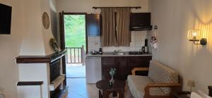 a kitchen and a living room with a couch and a table at Panorama Elatis in Elati