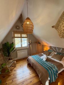 a bedroom with a large bed in a attic at Grande Villa au vert à 1h de Paris #reveillon #31 #seminaire in Treuzy-Levelay +122 photos