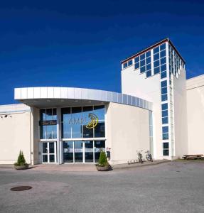 a large white building with a sign on it at Thon Hotel Verdal in Verdal