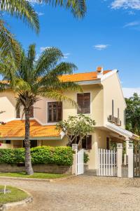 a house with a palm tree in front of it at Luxurious 3BRVilla Domaine Mui Ne with Pool & Tennis Court Access in Ấp Phú Tịnh (2)