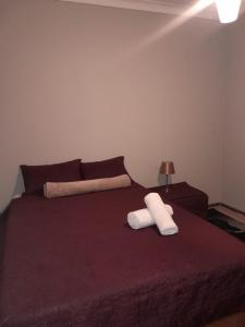 a bed with two white towels on top of it at Uptown Inn GuestHouse in Parys
