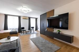 a living room with a large flat screen tv on a wall at Vidikovac-Berane in Berane +45 photos