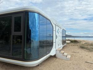 a building with large glass windows sitting on the beach at Space Capsules in Albena