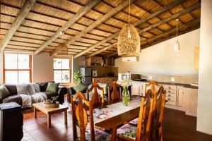 a kitchen and living room with a table and chairs at Skilpadvlei Wine Farm in Stellenbosch