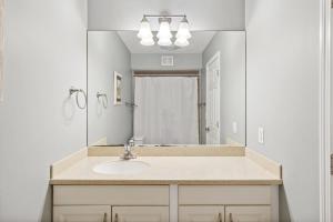 a bathroom with a sink and a large mirror at 891 Ketch Court in Hilton Head Island +54 photos
