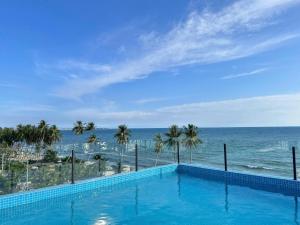 a swimming pool with a view of the ocean at Ripple house in Ấp Thiện Sơn