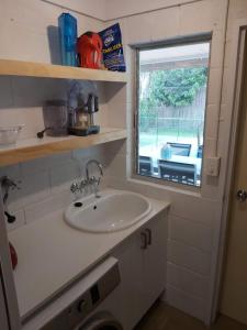 a bathroom with a sink and a window at Yaroomba Beach House in Yaroomba +13 photos